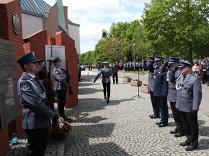 Komendant Wojewódzki z zastępcami oddają honor przed pomnikiem po złożeniu wieńca.