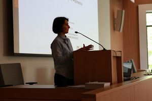 Kobieta przemawia do uczestników konferencji stojąc za mównicą